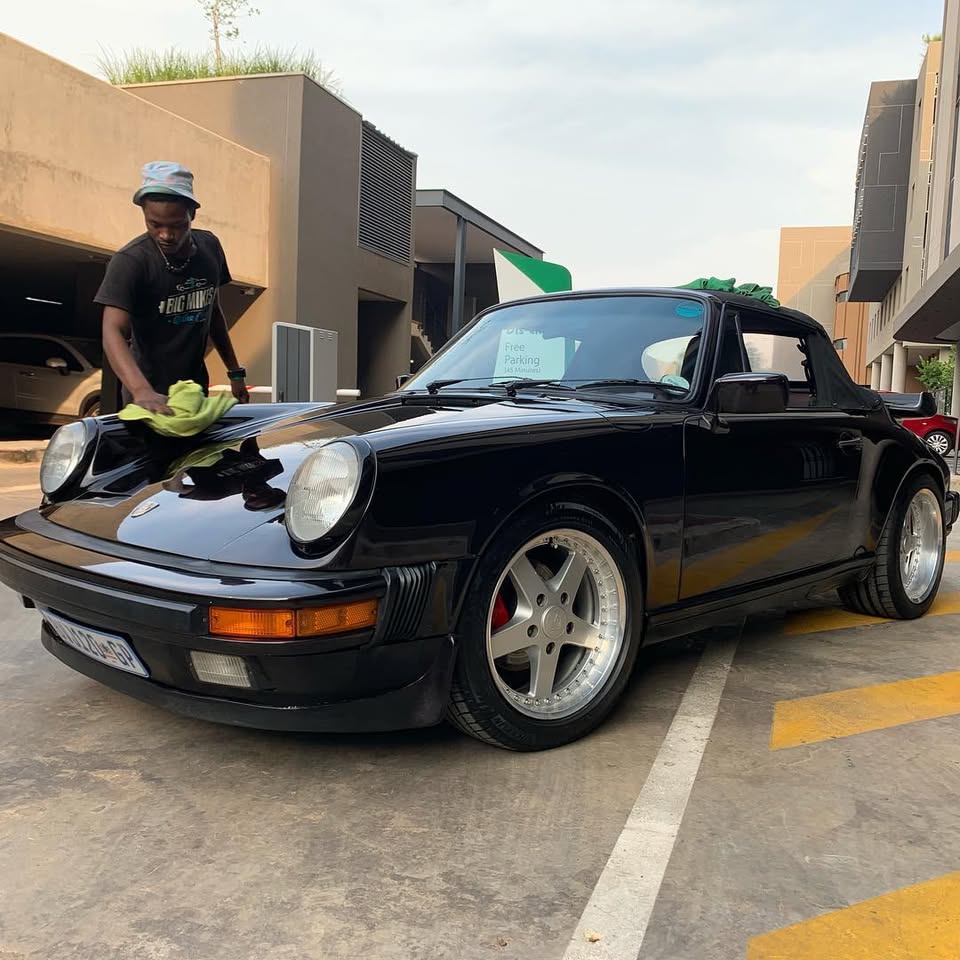 Big Mikes team member cleaning a Porsche